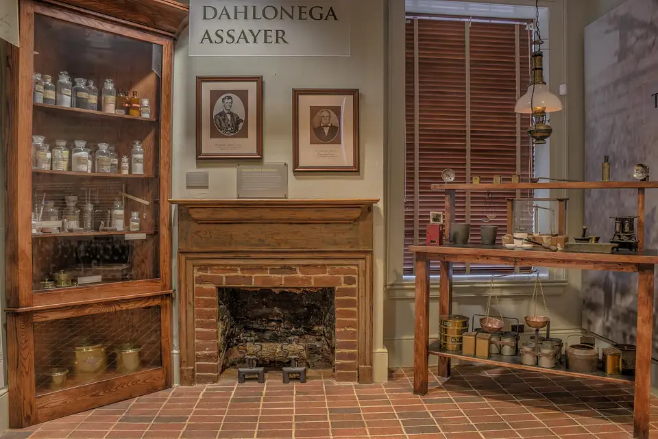 The recreated assayer's room in the Dahlonega Gold Museum, with jars, scales and a brick fireplace.